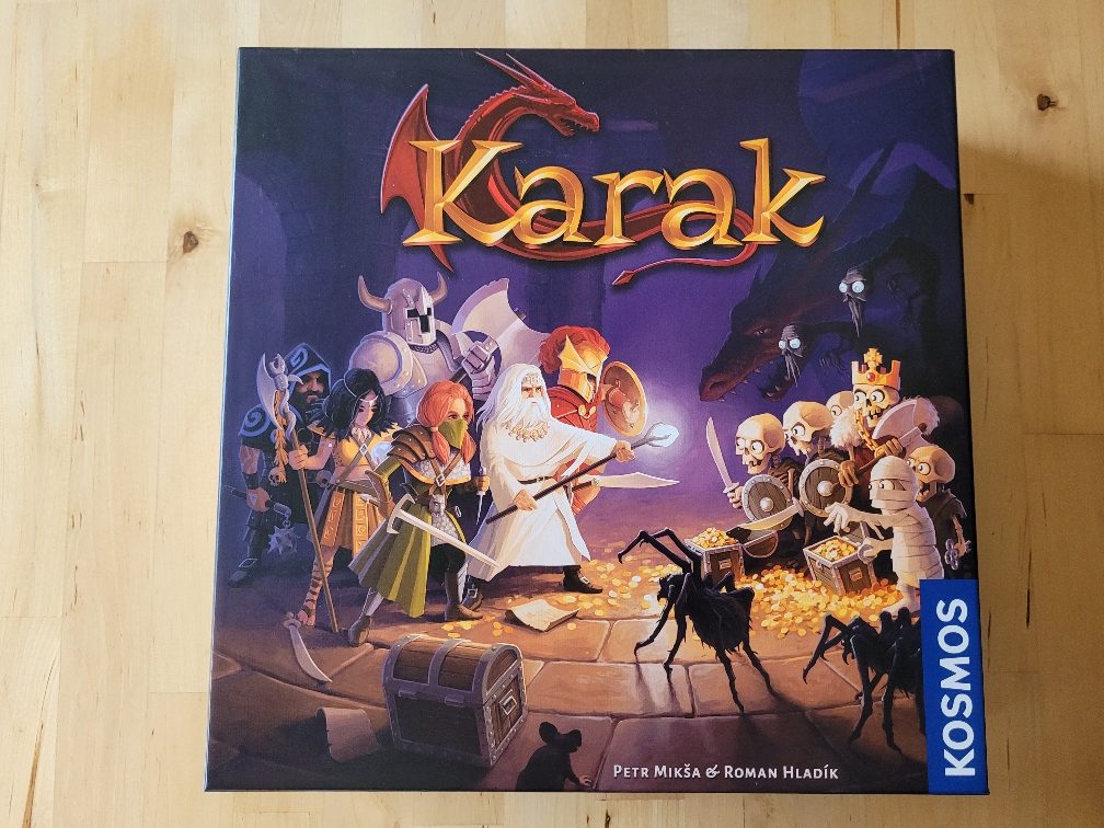 Das Cover von Karak mit Helden und Monstern und einem Drachen im Hintergrund.