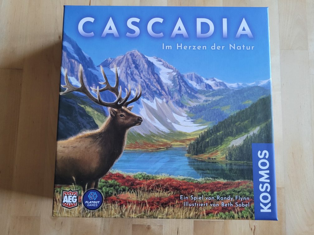 Das Cover von "Cascadia" zeigt einen Hirsch mit Gewei vo einer Gebirgslandschaft mit Fluss.