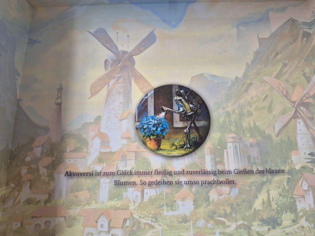 Ein Bild von einem Bot in Gießkannenform in der Spielschachtel.