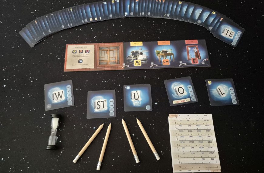 Das Spielmaterial von "Spukstaben" mit Karten, Stiften, Sanduhr und Block.