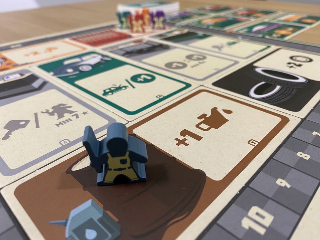 Eine Spielfigur auf einem Spielplanfeld von "Grease Monkey Garage".