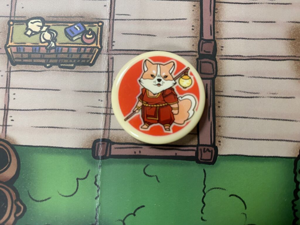 Ein Spielmarker mit einem Hund auf dem Spielplan.