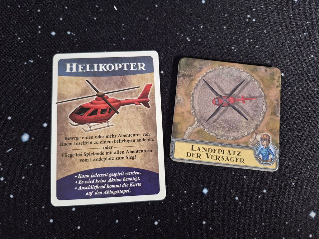 Eine Karte und ein Plättchen mit Text und einem Hubschrauber.