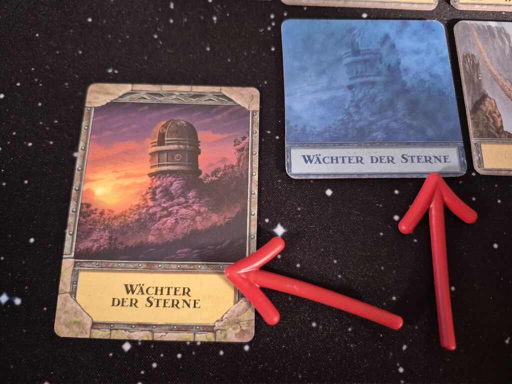 Eine Karte und ein Plättchen mit Text "Wächter der Sterne".
