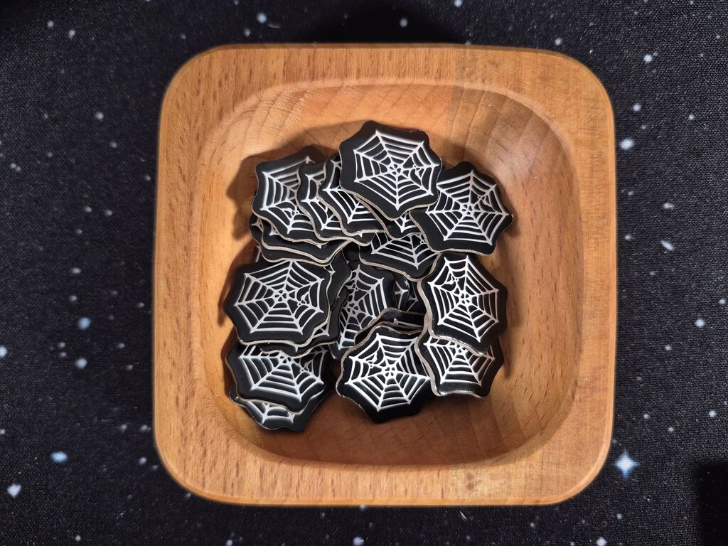 Eine Holzschale mit Spinnennetzmarkern.