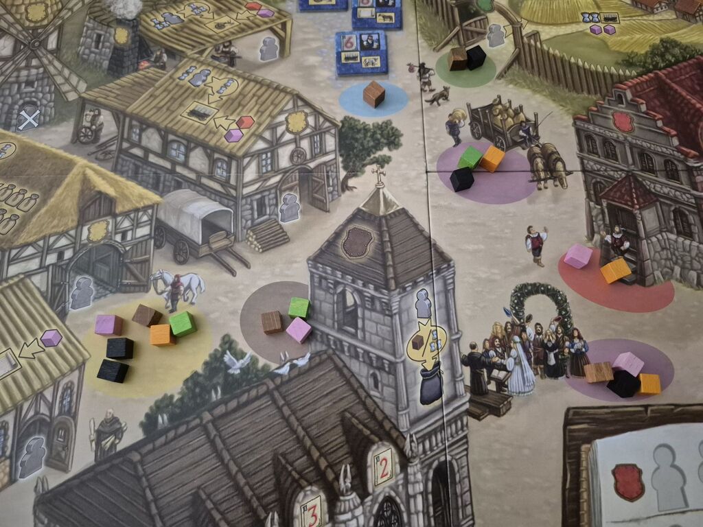 Bunte Würfel auf Feldern auf Spielplan von "Village".
