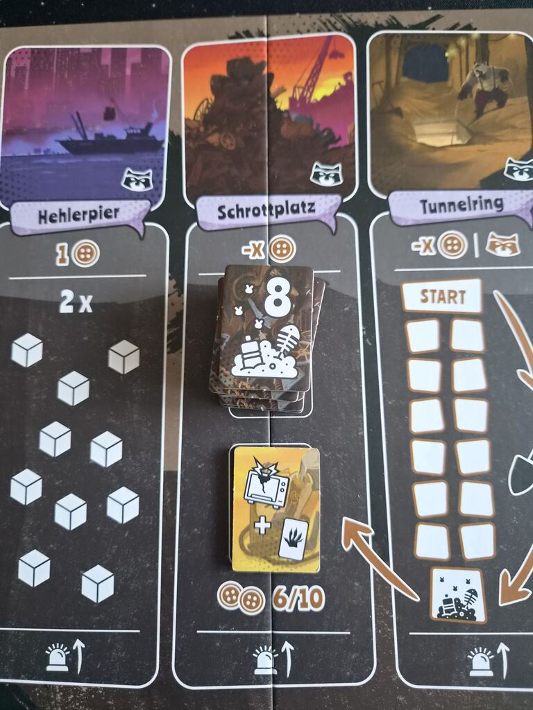 Plättchen mit Symbolen auf Spielplanausschnitt.